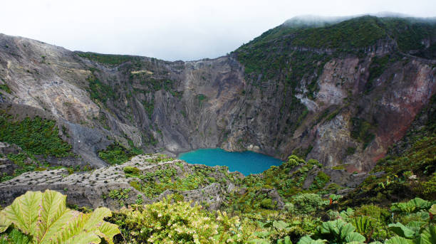 Costa Rica Irazu volcano in Costa Rica with a lake of green water formed in its crater irazu stock pictures, royalty-free photos & images