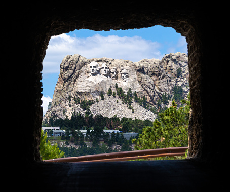 View of Mount Rushmore through tunnel in Custer State Park, South Dakota.