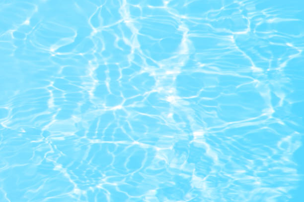 istock Defocus blurred transparent blue colored clear calm water surface texture with splashes and bubbles. Trendy abstract nature background. Water waves in sunlight with caustics. Blue water shinning 1459223260