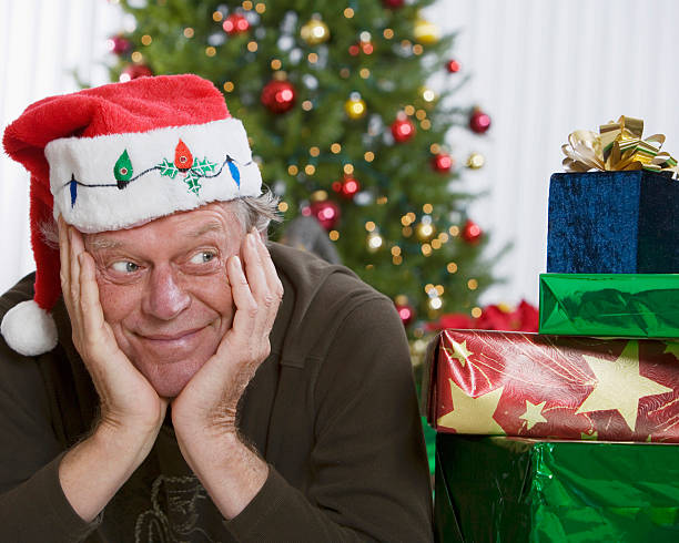 istock Senior man wearing Santa Claus hat 145922373