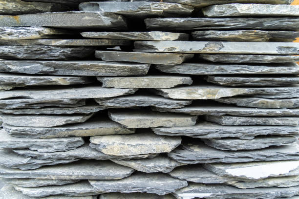 Stack flat slate stones cladding of wall used for flooring, walkways or wall decoration.Background texture