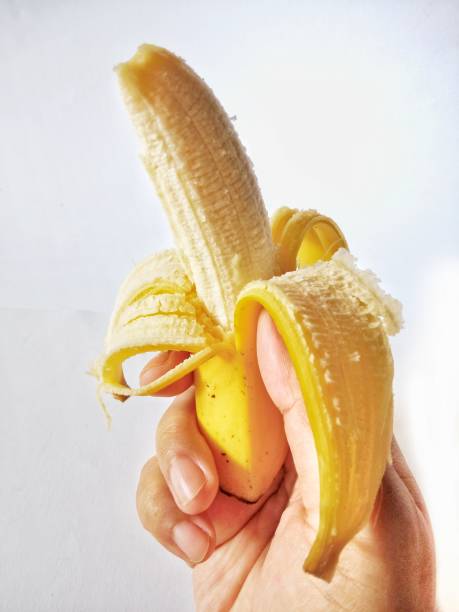 istock A hand holding a peeled banana 1459224786