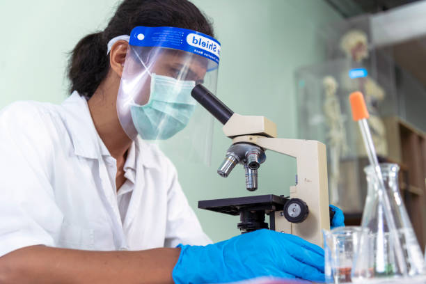 istock African american Scientist man look into Microscope research in science laboratory. Asian biochemistry scientist using microscope in laboratory chemistry labs. Medical research scientific experiment 1459229586