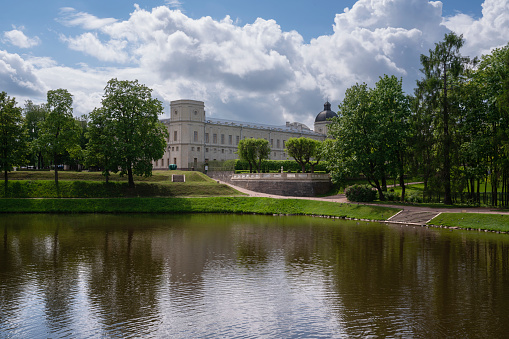 Palace and park ensemble of Gatchina Park: Karpin Pond, Gatchina Palace, private palace garden on a sunny summer day, Gatchina, St. Petersburg, Russia