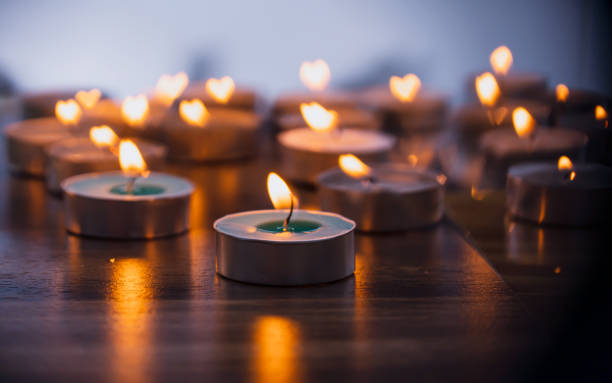 luz de velas en habitación oscura - tea light fotografías e imágenes de stock