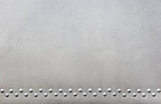 silver metal with rivets silver metal with rivets riveted metal texture stock pictures, royalty-free photos & images