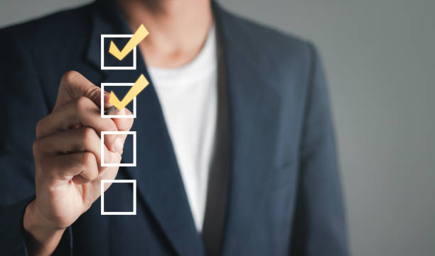 istock Checklist concept. Businessman checking mark on checkboxes, copy space. 1459237506
