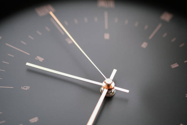 istock The black wall clock has gold hands that look elegant and modern. 1459238840