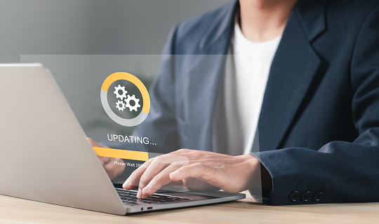 Businessman working and Installing update process. Software update or operating system upgrade to keep the device up to date with added functionality in new version and improve security.