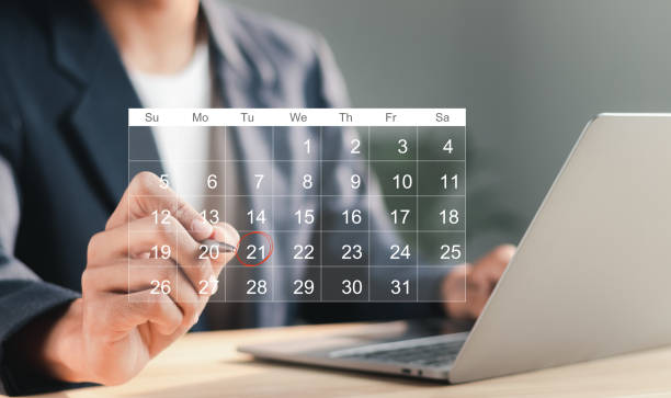 istock Businessman manages time for effective work. Calendar on the virtual screen interface. Highlight appointment reminders and meeting agenda on the calendar. Time management concept. 1459240691