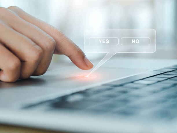istock Yes or No choosing concept. Yes and No buttons window in virtual speech bubble appear while finger of business person touching on touchpad on laptop computer, close up. 1459241603