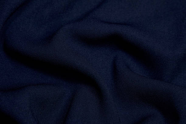 istock Black fabric background. Black cloth waves background texture. Black fabric cloth textile material. 1459241880