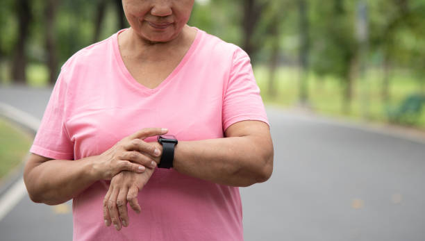 istock Mature Adult female checking pulse 1459243433
