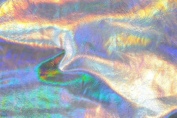 istock Holographic metallic background.metallic texture with iridescent gradients. wallpaper In silver, purple and green colors.metal holographic material. texture with iridescent waves and folds 1459246390