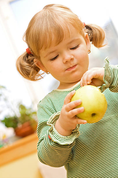 istock Cute girl with apple 145924758