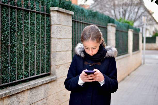 istock Girl looking at her phone 1459248116