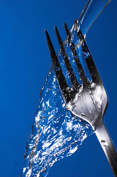 Fork under water stock photo