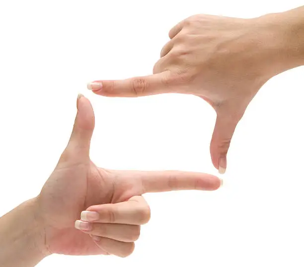 Female hands forming a frame. Isolated on a white background.