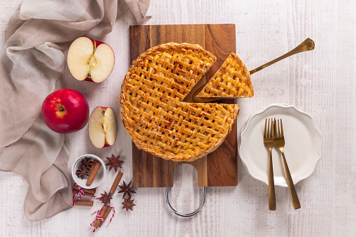 Classical american fall dessert Apple Pie on a white wooden table