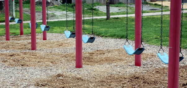 a row of swings at a playground