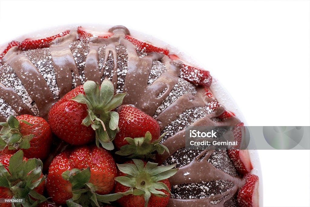 Chocolate Bundt Cake From Top Chocolate Bundt cake with chocolate glaze and fresh strawberries. Shot from above, background dropped out for easier design implementation. Large dof .. most all in focus. Berry Fruit Stock Photo