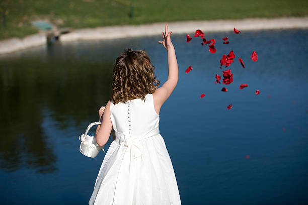 Little girl in white dress and princess crown, she poses for the camera with a beautiful look, copy space, children's day theme.