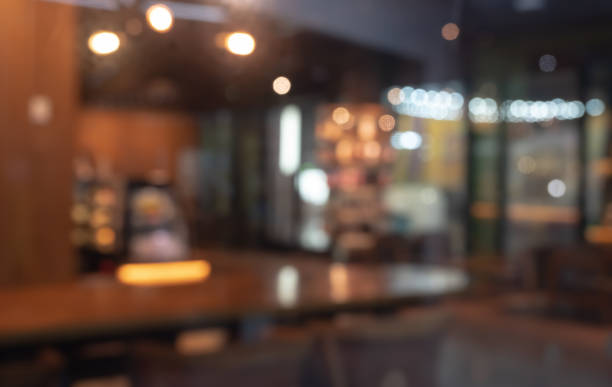 Abstract blurred image of cafe or restaurant with bokeh lights background at night Defocused image of shop or cafe with bokeh coloful night lights background office window night stock pictures, royalty-free photos & images