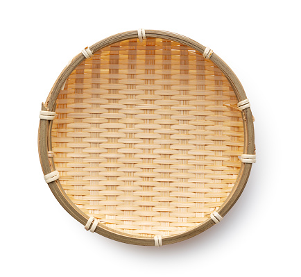 Bamboo colander placed against a white background. Viewed from above.