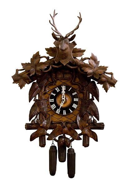 Cuckoo Clock Old wooden cuckoo clock isolated on a white background. Manufactured at the beginning of the 20th century. black forest photos stock pictures, royalty-free photos & images