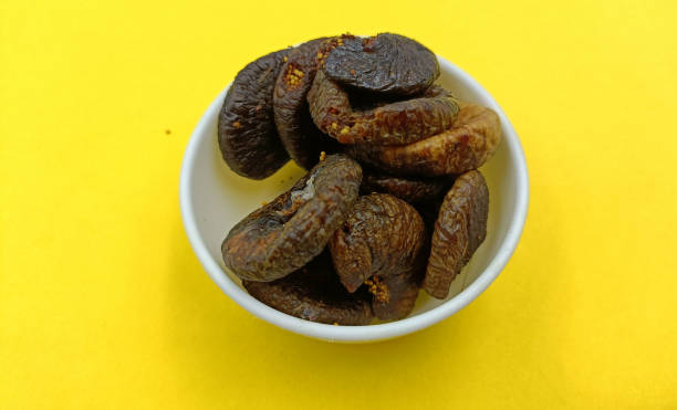 istock Dried fruits on a yellow background. Dried fig. 1459264128
