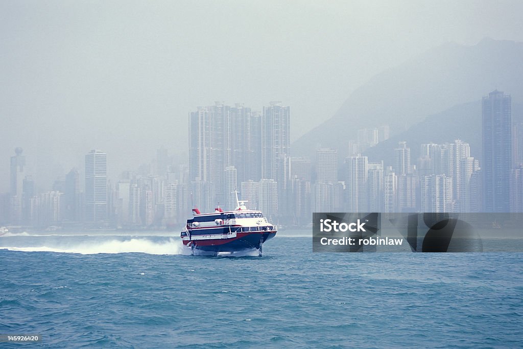 Hydrofoil in Harbour A hydrofoil speeding away from Vitoria Harbour, Hong Kong. Ferry Stock Photo