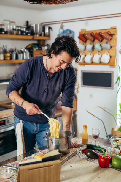 istock man prepares food in kitchen 1459264345