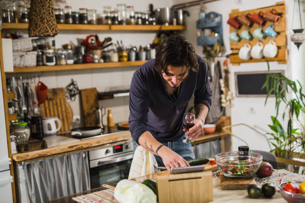 istock man prepares food in kitchen 1459265709