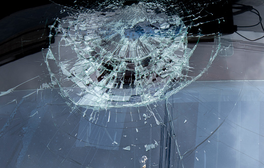 The windshield of the car was broken due to an impact.