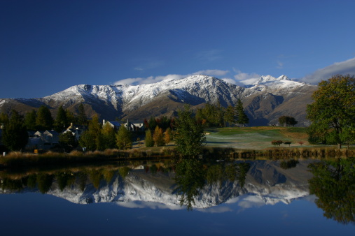 The Remarkables (Queenstown, South Island, New Zealand) are reflected in one of the ponds at Millbrook Golf Resort.