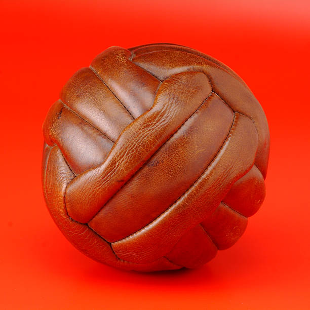 istock old brown ball soccer in red bakground 145927137