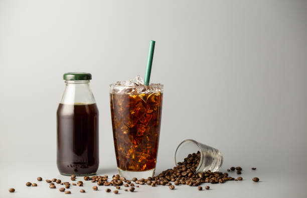 istock Iced americano coffee with coffee beans on grey background, Black coffee glass package for takeaway. Cold beverage product. 1459273567