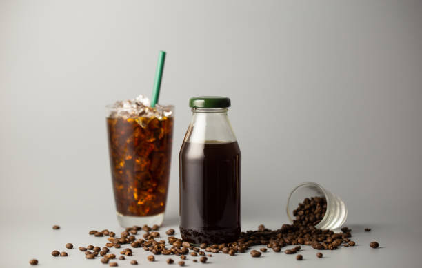 istock Iced americano coffee with coffee beans on grey background, Black coffee glass package for takeaway. Cold beverage product. 1459273570