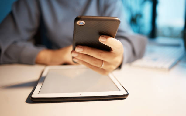 istock Smartphone, tablet and hands at office desk for digital marketing, multimedia application and software company update. Creative, corporate and productivity business woman using phone for social media 1459274182