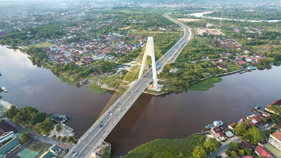 Aerial view of Siak Bridge IV (Abdul Jalil Alamuddin Syah Bridge) above Siak River (Sungai Siak) in Pekanbaru top view.