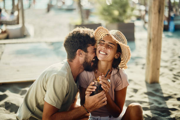 młoda szczęśliwa zakochana para bawiąca się w kawiarni na plaży. - young adult beach people cheerful zdjęcia i obrazy z banku zdjęć