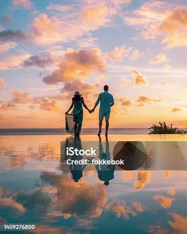 istock couple watching sunset at infinity pool Saint Lucia, couple on vacation tropical Island of St Lucia 1459276800