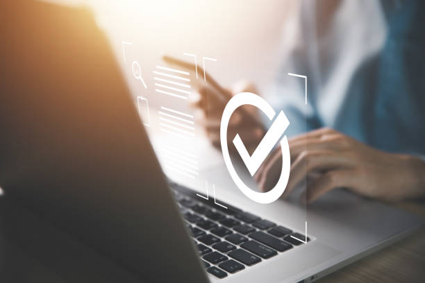 istock Businessman using smartphone and laptop display digital technology check icon symbol Best Quality Assurance Service 1459278197