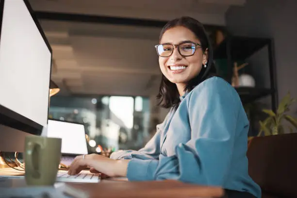 Photo of Space, computer and portrait of woman in office at night, working and research idea with mockup screen. Mock up, happy and businesswoman search online for creative design, inspiration and ppt review