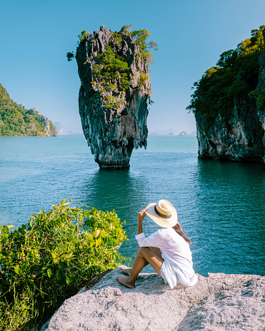 woman on vacation in Thailand, girl visit Phangnga Bay Thailand James Bond Island, Asian women with hat on a trip to James Bond Island in Phannga bay