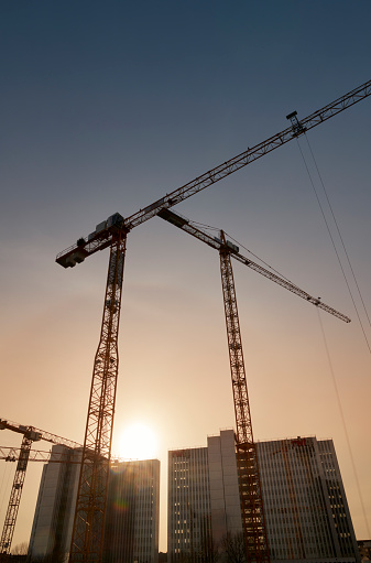 Düsseldorf, Germany- Jan., 10, 2023: Silhouettes of cranes and office buildings in the development area of „Media Harbor“, Düsseldorf.