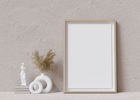 Vertical picture frame mock up. Empty frame standing on the floor. Copy space to show your artwork. Pampas grass in vase, sculpture. 3D rendering