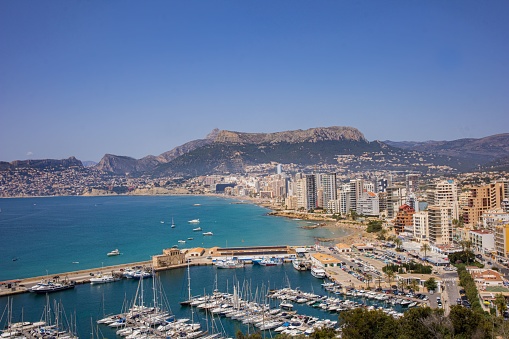 A beautiful view of the seaport and the promenade of the Prince of Asturias in Calpe, Spain