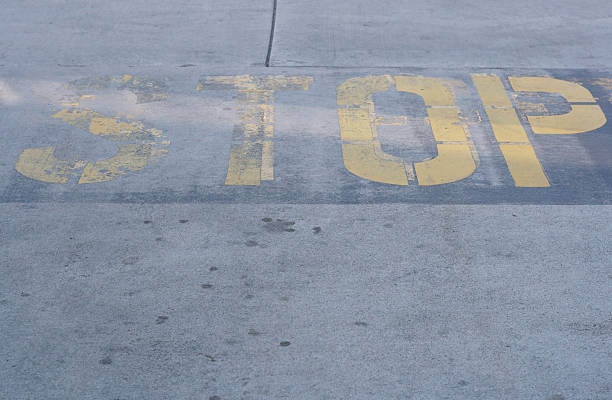 istock Stop sign written on concrete ground 145928660