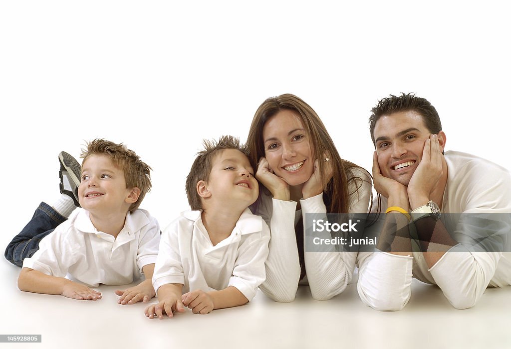 Family portrait, casual pose. All dressed in white Casual portrait of a healthy, attractive young family taking a break and relaxing 20-29 Years Stock Photo